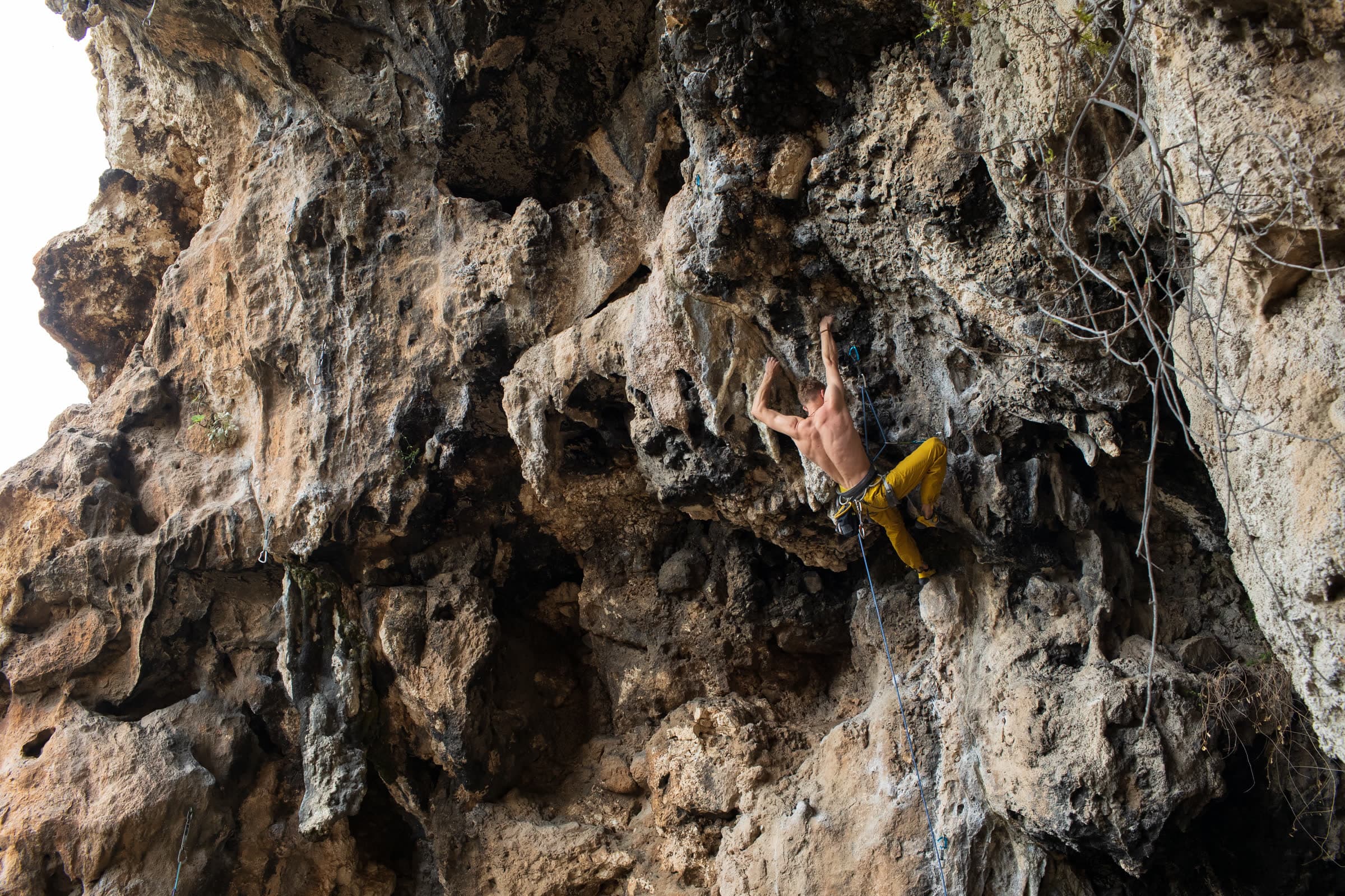 A climber on an overhanging limestone wall